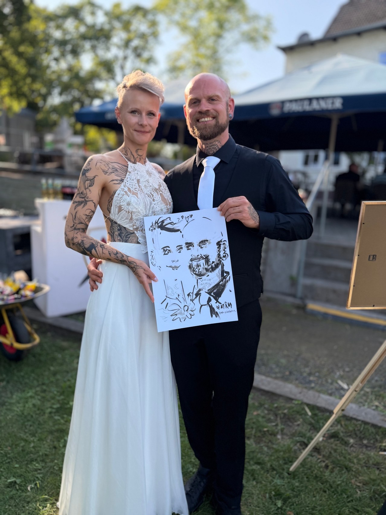 Brautpaar präsentiert seine live gezeichnete Karikatur bei einer Hochzeit